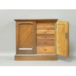 A late Victorian oak miniature collector's cabinet, the two panelled doors enclosing six drawers