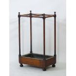 A mahogany stick/umbrella stand, with turned supports, and a tin tray, 80cm high