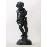 An early 20th century lead garden figure of a boy holding a sheaf of wheat, now painted black,