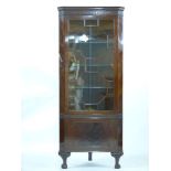 A mahogany corner cupboard, having an astral glazed cabinet top over a cupboard, on claw feet, 189cm