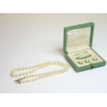 A single row graduated cultured pearl necklace, with a silver clasp, a sterling silver green and