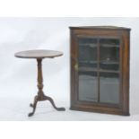 A George III oak corner cupboard, and a mahogany tripod table