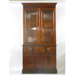 A mid 19th century and later mahogany secretaire bookcase, with a glazed top over a secretaire