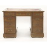 An Edwardian mahogany nine drawer kneehole desk, 106cm wide