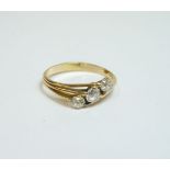 A three stone diamond diagonal ring, with split shoulders, finger size N