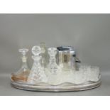 An oval silver plated tray, 61cm, four decanters and stoppers, eight whiskey tumblers, and an ice