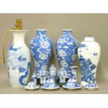 A pair of Chinese blue and white baluster vases and covers, prunus decoration, four character marks,