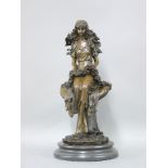 A reproduction bronze of a young woman sitting on a toadstool