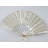 A 19th century fan, with plain mother of pearl splines, and with an embroidered silk ground of a