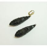 A pair of carved jet pippin drop earrings, one later fitting, one deficient