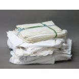 A collection of table linen, including damask tablecloths and napkins