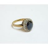 A 9ct gold oval sapphire and diamond cluster ring, finger size K