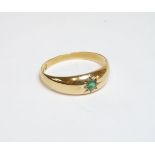 An 18ct gold single stone star set gypsy ring, Chester 1900, with a later emerald, finger size S