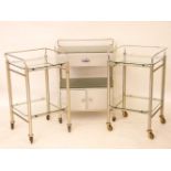 A two tier glass top side table, with drawer and cupboard, 64cm wide, and a pair of two tier