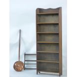 A narrow oak open bookcase, 61cm wide, an Ercol wall shelf, and a copper warming pan