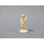 A late 19th century ivory bottle stopper terminal, modelled as a man pouring himself a drink, 5.