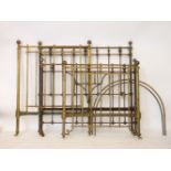 A brass single bed, and a cast iron and brass double bed, in need of restoration