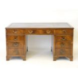 A mahogany nine drawer pedestal desk, 151cm wide, 77cm high, 92cm deep approximately