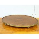 A George III mahogany oval tray, with a brass border on claw and ball feet, 51.5cm wide