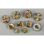 Three perspex buttons, circa 1950, engraved and painted with butterflies, four similar examples, two
