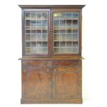 A mid 19th century mahogany glazed bookcase, with a plain cornice, over leaded glazed cupboard, over