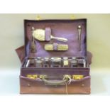A purple leather dressing case, fitted with silver fittings, incomplete