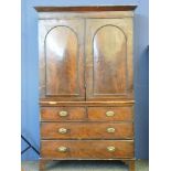 A Victorian mahogany linen press, with arched cupboard, enclosing slides, over two short and two