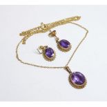 An amethyst pendant and earring suite, marked 9ct, on an 18ct gold chain