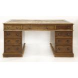A Victorian mahogany partners' desk, the leather inset top over nine drawers and three drawers and