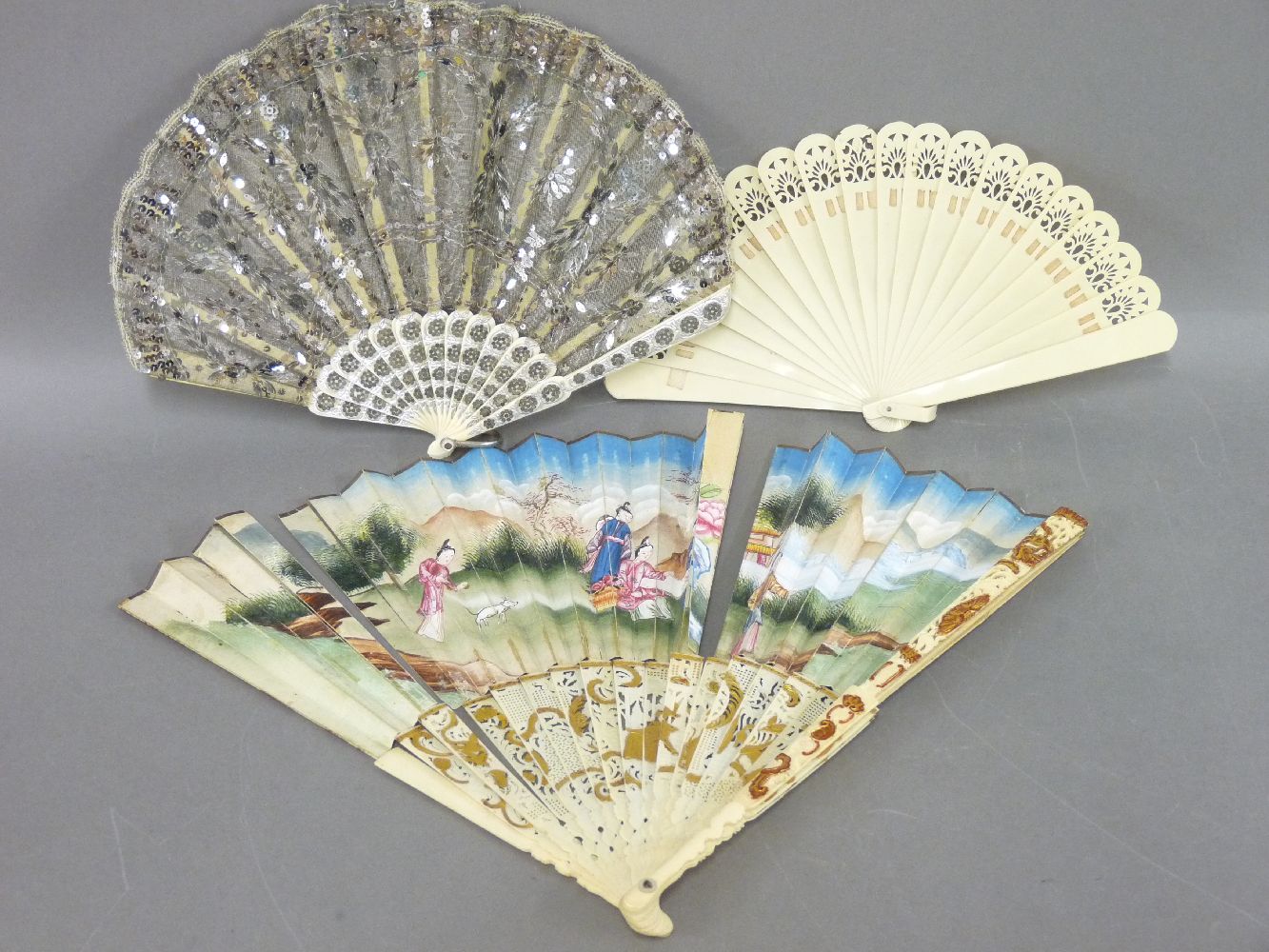 A Spanish fan, in bone and lace, 20cm, and two further fans, two boxed