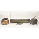 A copper log bin, a brass fender on paw feet, a coal bin, bellows, and fire tools