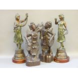 A pair of carved Burmese figures of dancers, and a pair of spelter figures