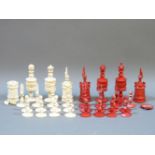A 19th century carved ivory chess set, one side stained red, the other natural, king 11.2cm, pawn