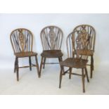 A set of four wheelback chairs, one chair a/f