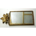 A 20th century giltwood and gesso wall mirror, with a stylised fleur de lys crest, 110cm high, now