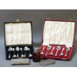 Two boxes of silver teaspoons, a silver cigarette case, bottle, etc