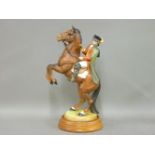 A Beswick 'Highwayman' figure, by Albert Hallam, seated on a rearing horse, 32cm high, on a wood