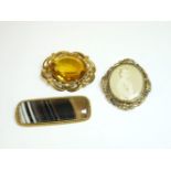 A Victorian gold memorial swivel brooch, a yellow paste Victorian rolled gold brooch, and an agate