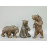 Three Black Forest bears, one seated, one standing, one on all fours, 21.5cm high
