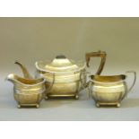 A silver three piece teaset, all on ball feet, retailed by Hamilton & Inches