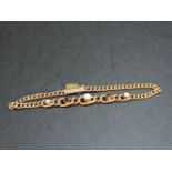 An Edwardian gold graduated curb chain bracelet, set with opals and rubies