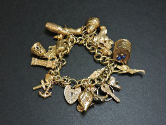 A 9ct gold charm bracelet, with a collection of 9ct gold charms, including a kettle and dolphin