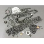 A black glass bead sautoire, a black glass bead tassle, a three row jet bead necklace, and