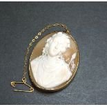A 9ct gold carved shell cameo brooch/pendant, depicting Ariadne carrying the rod of Dionysus