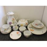 A 20th century Meissen part tea and coffee set, white ground with flora motif and gilt rims, cross