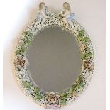 A 19th century Sitzendorf wall mirror, with shaped all over floral cherub decoration