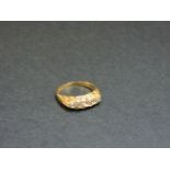 An 18ct gold five stone diamond carved head ring