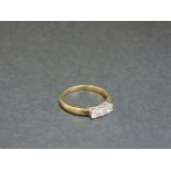A 9ct yellow and white gold three stone diamond ring