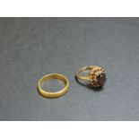 A 9ct gold oval garnet cluster ring, and a 22ct gold wedding ring