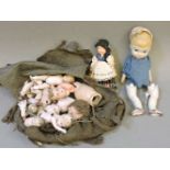 A collection of ceramic, bisque and other doll parts